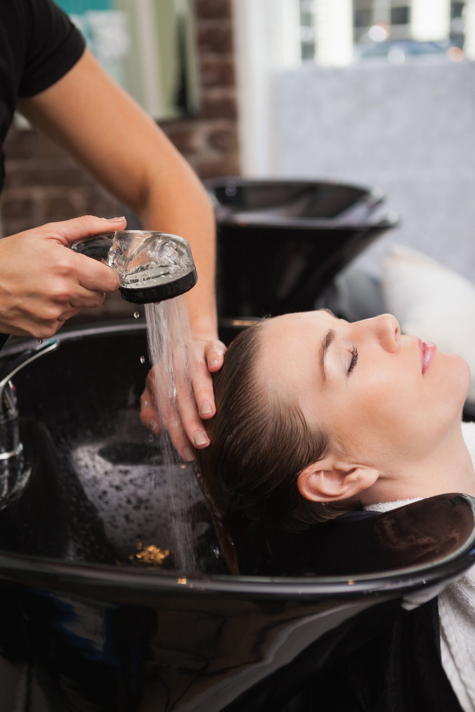 Customer getting their hair washed in a salon